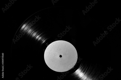 78 rpm vinyl disk with white label on dark background