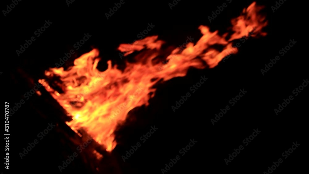 Fire flame caused by burning of wood on a black background Fire flame caused by burning of wood on a black background