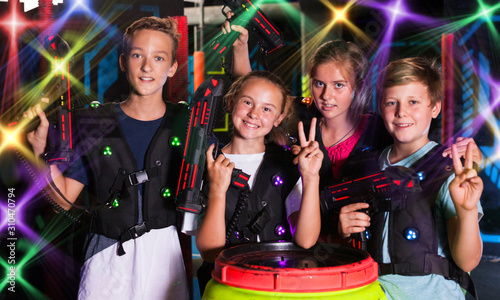Girls and boys posing with laser pistols