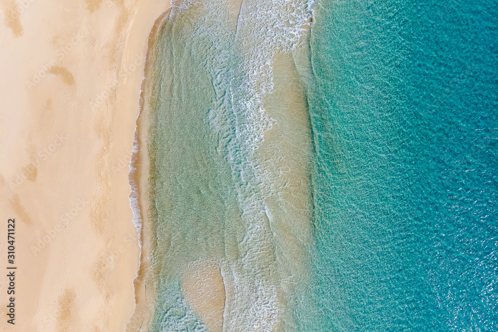 Amazing Beach and waves from top view. Turquoise water background. Summer seascape from air. Summer Background. Top view from drone. Travel concept and idea. North Cyprus, Golden Beach.