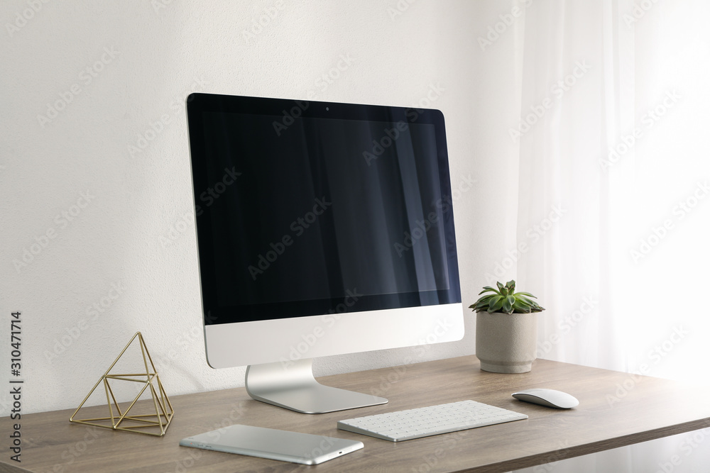 Workplace with computer and plant on wooden table. White background Workplace with computer and plant on wooden table. White background