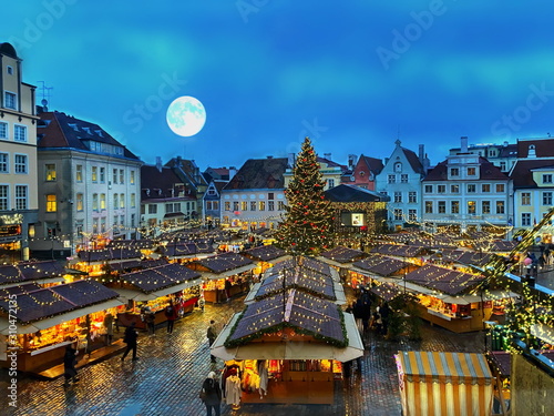 Canvas Print Christmas tree in Tallinn old town hall square without snow ,moon on blue sky ,b