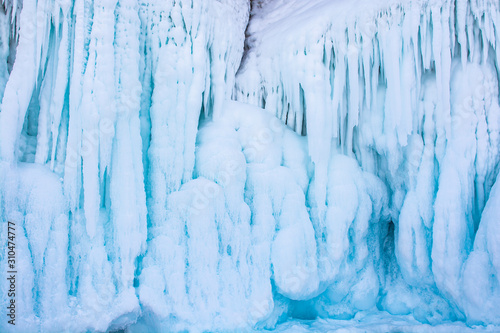 Blue ice stalactite on cliff, winter season in Siberia, Russia, nature background image