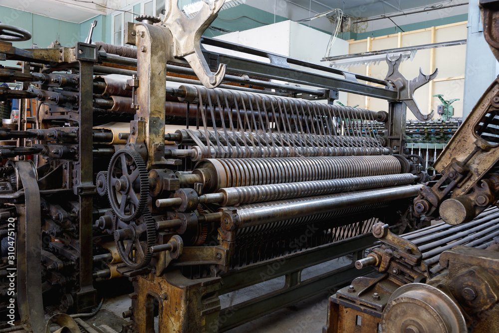 An old machine at an abandoned textile factory An old machine at an abandoned textile factory