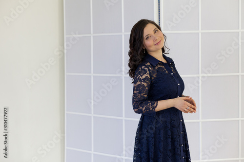 Portrait of a beautiful fashionable Asian woman in a dark blue dress