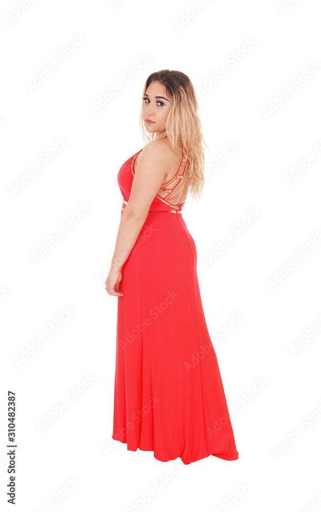 Beautiful blond woman standing in red dress in profile