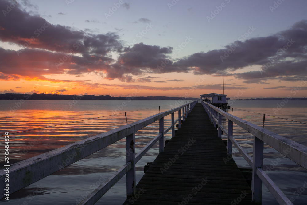 picturesque wooden pier at sunset with colorful sky