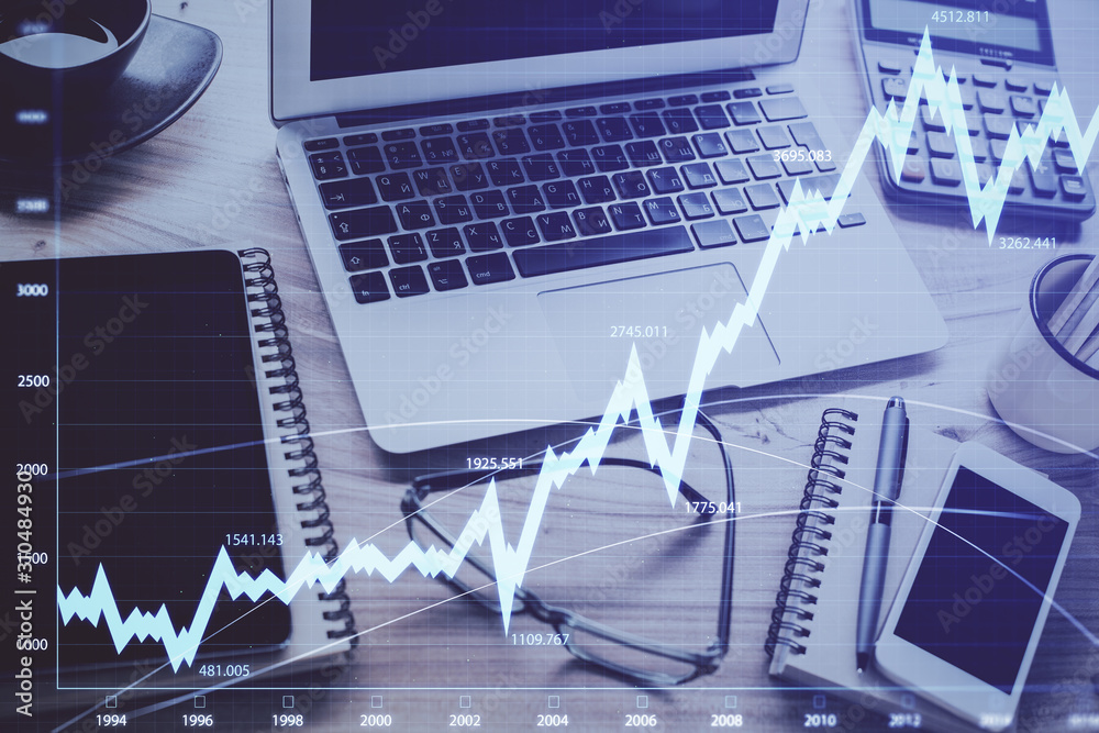 Forex market chart hologram and personal computer background. Multi exposure. Concept of investment. Forex market chart hologram and personal computer background. Multi exposure. Concept of investment.