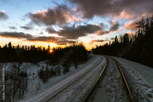 Vibrant sunset over winter train tracks