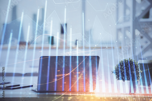 Stock market graph and table with computer background. Double exposure. Concept of financial analysis.