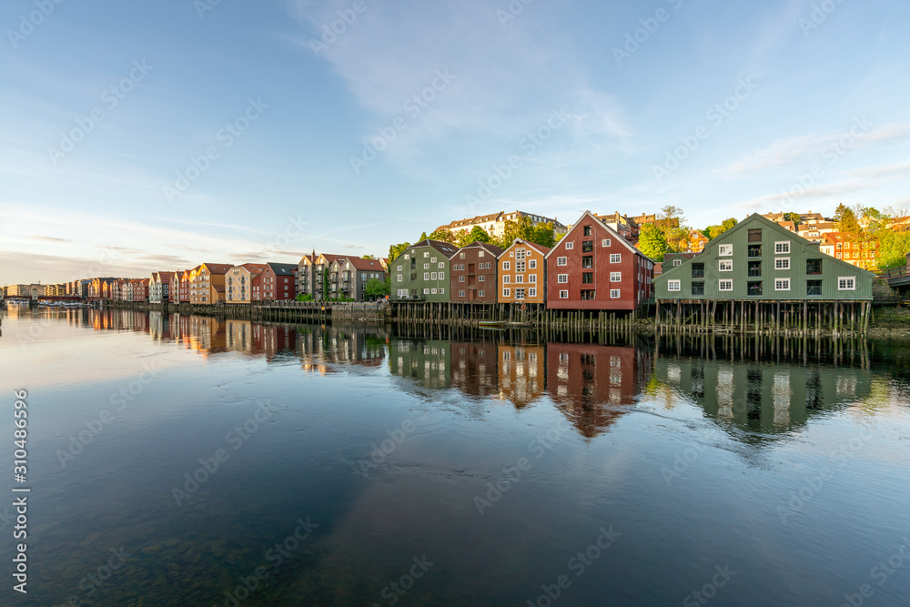 Fototapeta premium Colorful wooden buildings near Nidelva river in the city of Bakklandet/Trondheim in Norway. Architecture, buildings, travel and photography concept.