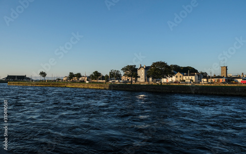 View of the river Corrib flowing through Galway city. Taken on a sunny summer morning at sunrise.