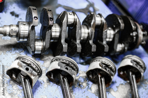 Photography crankshaft and pistons with connecting rods on the table