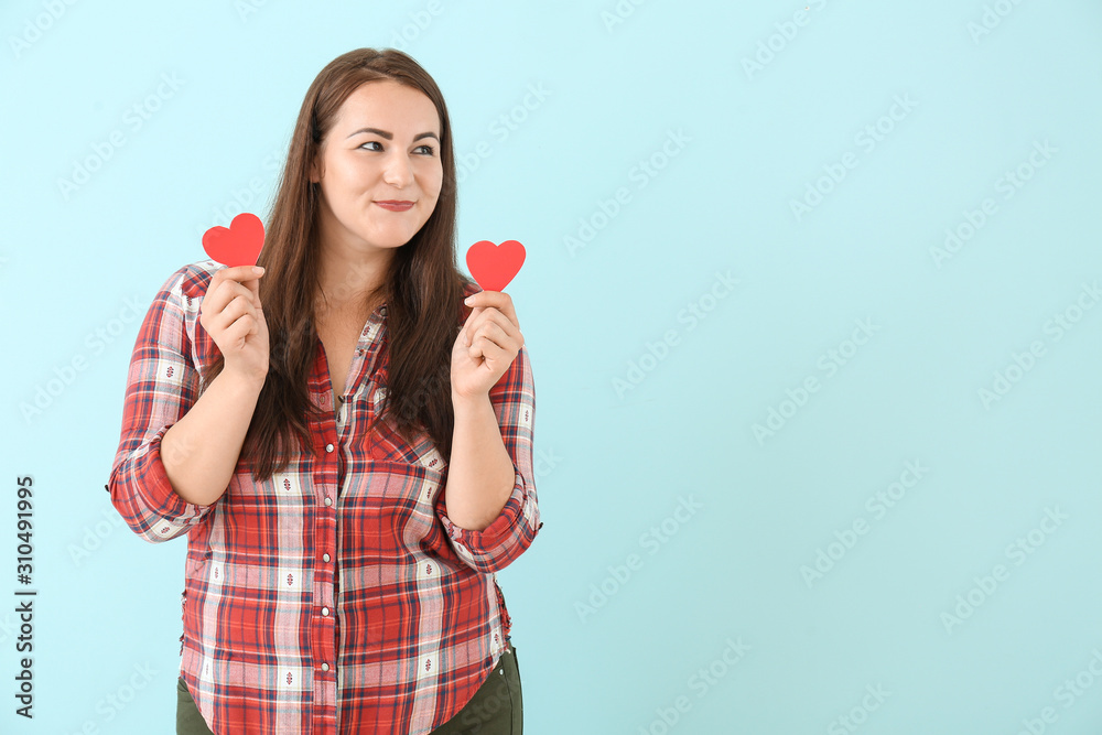 Beautiful young woman with small red hearts on color background Beautiful young woman with small red hearts on color background