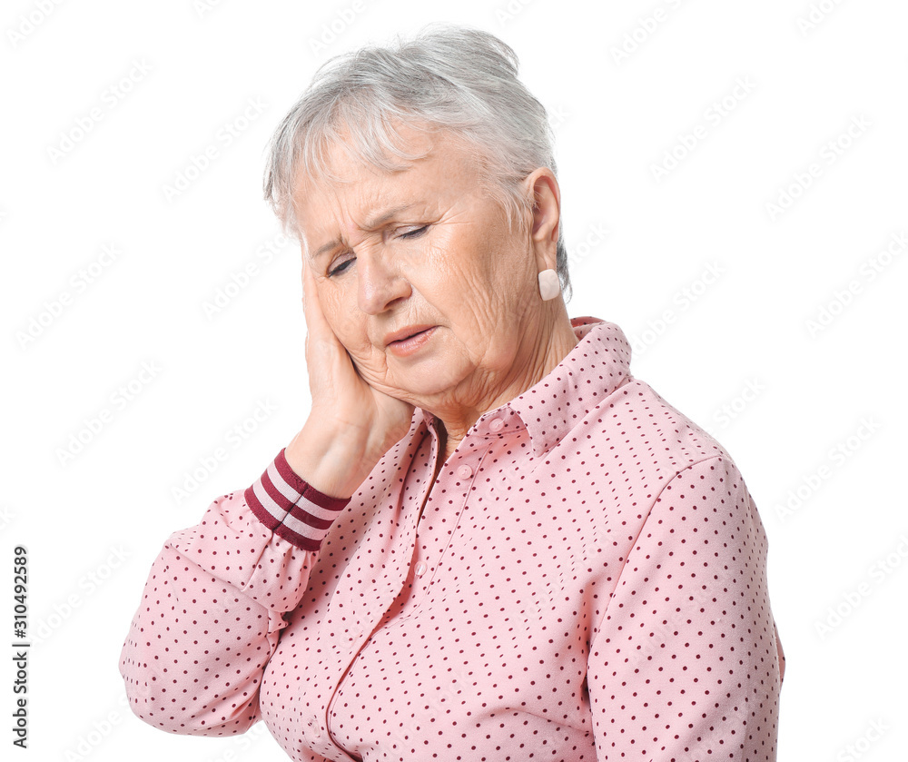 Senior woman suffering from toothache on white background