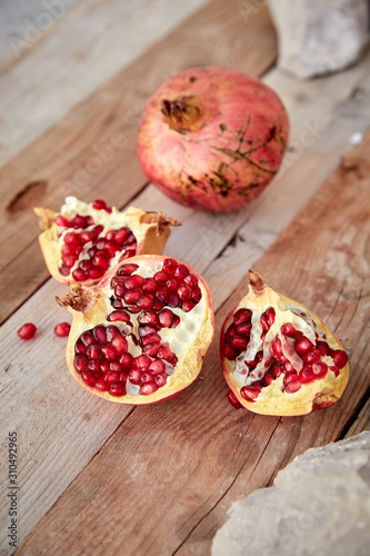 ripe organic pomegranate on teh wooden background