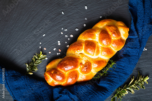 Photos Homemade food concept fresh baked bread braid challah or brioche on black slate