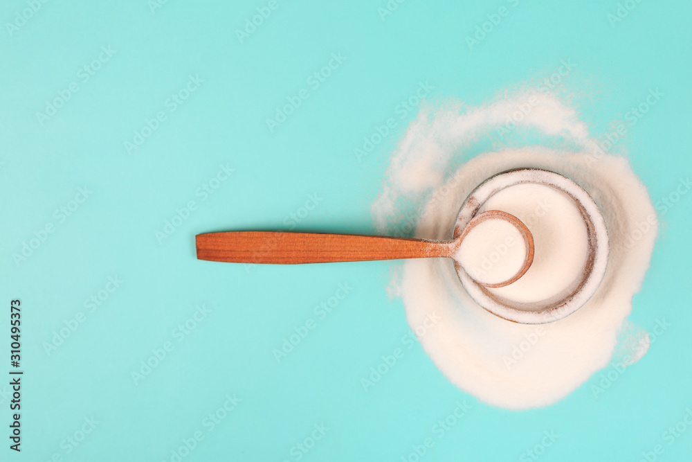 Collagen or protein in powder on teal background.