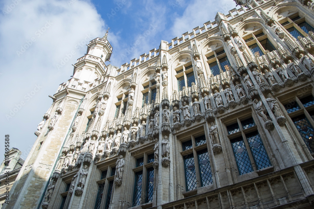 The Town Hall of the City of Brussels is a Gothic building from the Middle Ages. It is located on the famous Grand Place in Brussels, Belgium. Side view from bottom to top.