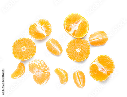 Pieces of sweet tangerines on white background