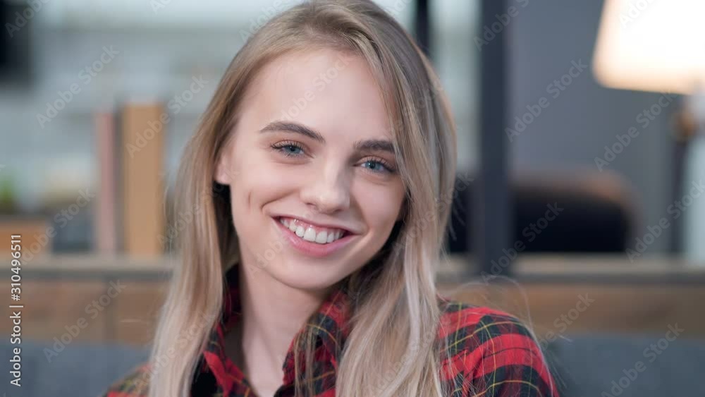 Close up portrait of smiling young woman doing bye bye, or hi gesture. Waving hand and looking at the camera. Close up portrait of smiling young woman doing bye bye, or hi gesture. Waving hand and looking at the camera.