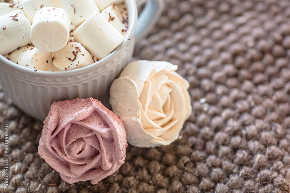 Marshmallow looks like rose close-up. cup with small marshmallows sprinkled with grated chocolate on cotton knitted napkin. Marshmallow looks like rose close-up. cup with small marshmallows sprinkled with grated chocolate on cotton knitted napkin.