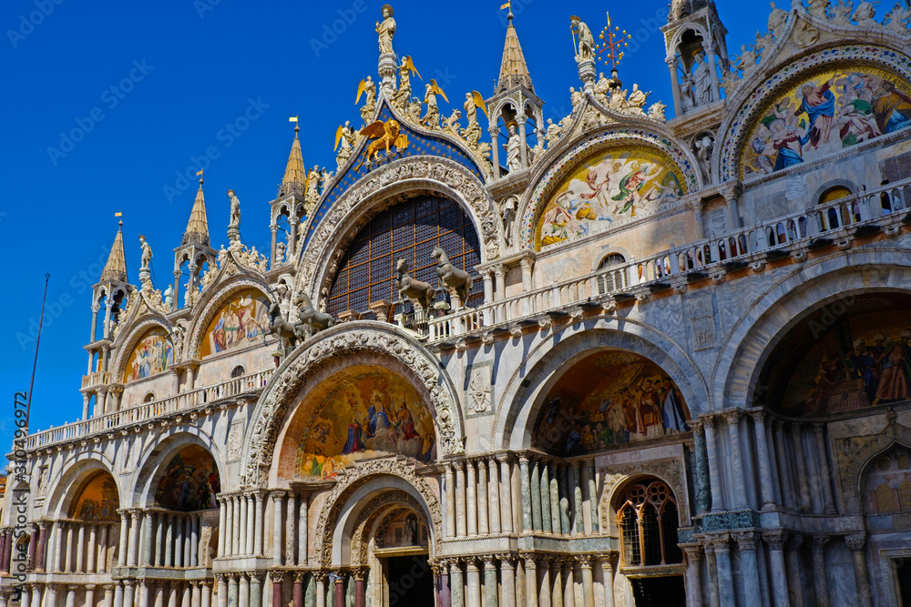 Basilica di San Marco under blue sky, Venice, Italy. Saint Mark Basilica and Doge's Palace. Cathedral of San Marco. Roof architecture details with lion, symbol of the City of Venice. 