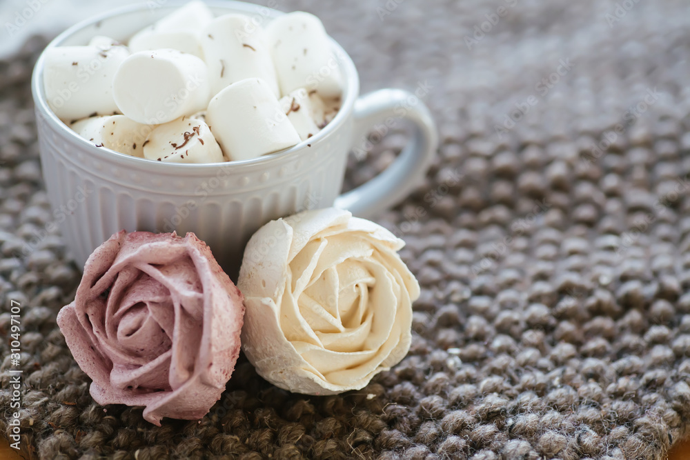 Marshmallow looks like rose close-up. cup with small marshmallows sprinkled with grated chocolate on cotton knitted napkin. Marshmallow looks like rose close-up. cup with small marshmallows sprinkled with grated chocolate on cotton knitted napkin.