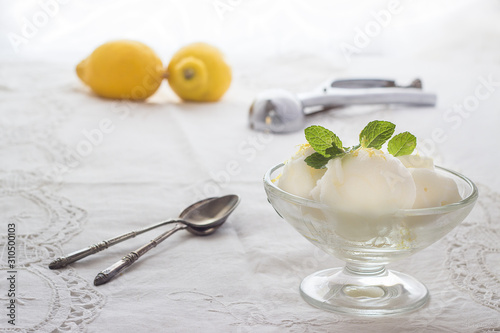 Lemon ice cream with spoons and lemons