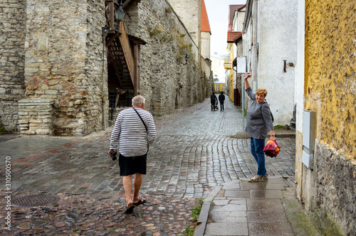 A Mature married couple walks the streets of the old city.