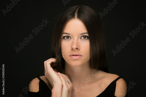Portrait of beautiful young woman on black background