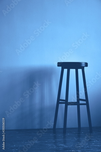 Classic blue color high stool. Monochrome background. Copy space.