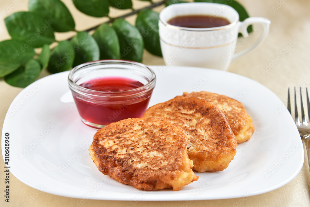 Fritters on a white plate with cherry sauce Fritters on a white plate with cherry sauce