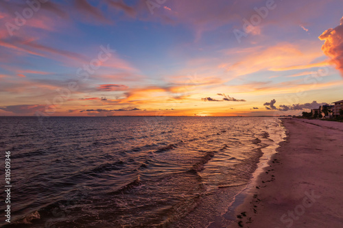 Sunset on of the coastline on Florida beach empty beach dramatic pastel sky illuminating the beach and waves