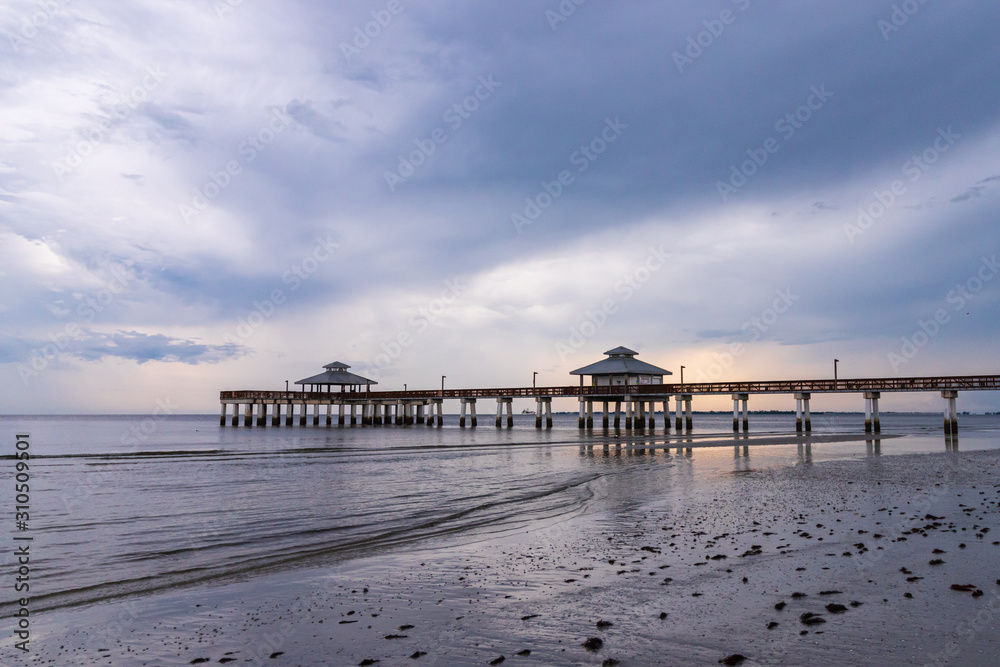  Fishing Pier on a South west Florida Beach during sunset after a storm days before hurricane Dorian calm and relaxing