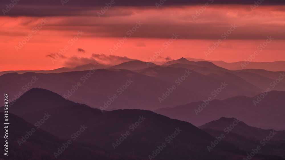 Splendid mountain sunrise. Mountains silhouettes on a beauty background. Bieszczady Mountains Poland.