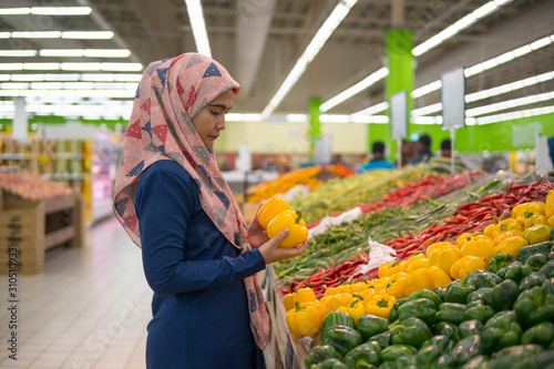 Selective focus Asian adult woman do grocery shopping at supermarket.