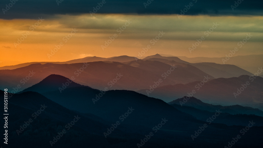 Splendid mountain sunrise. Mountains silhouettes on a beauty background. Bieszczady Mountains Poland/Ukraine