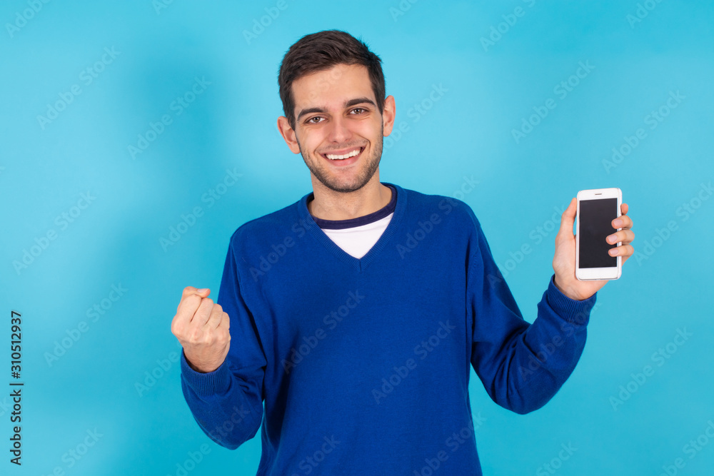 casual young hipster man with mobile phone isolated on color background casual young hipster man with mobile phone isolated on color background