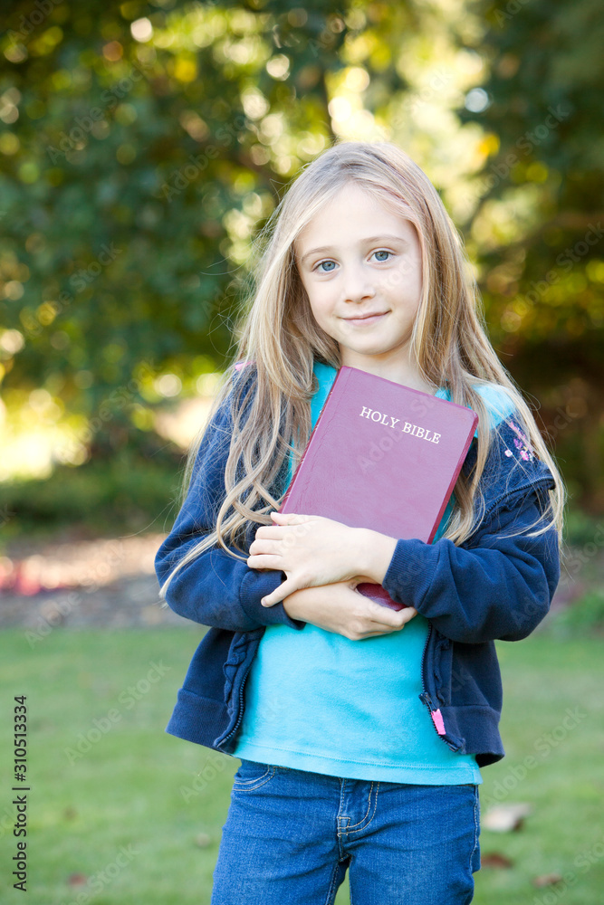 Little Girl Holding Bible Outdoors Stock Photo Adobe Stock