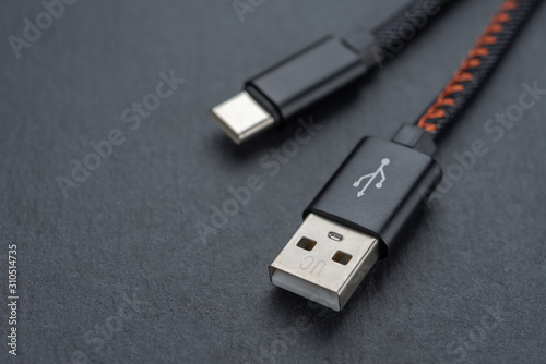 Type C USB cable with cable against a dark background.