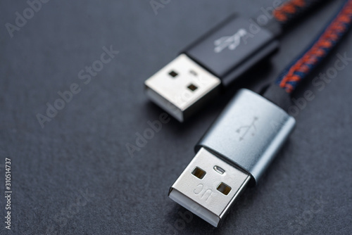 USB cable with cable against a dark background.