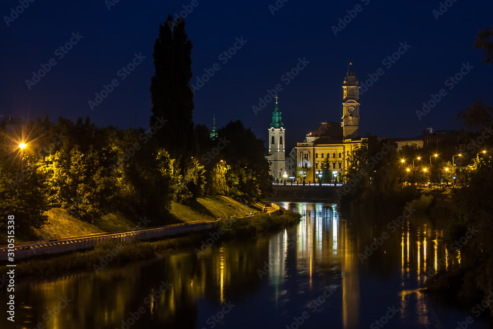 View of Oradea City Hall tower and river Crisul Repede in night