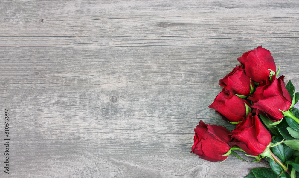 Fototapeta Valentine's Day Holiday Beautiful Red Flower Roses Bouquet Over Wood Texture Rustic Background Horizontal with Copy Space