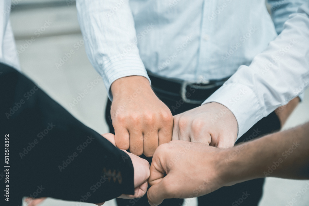 Business people join hand together during their meeting Business people join hand together during their meeting