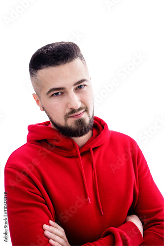 Handsome man in red casual clothes posing with arms crossed on white background