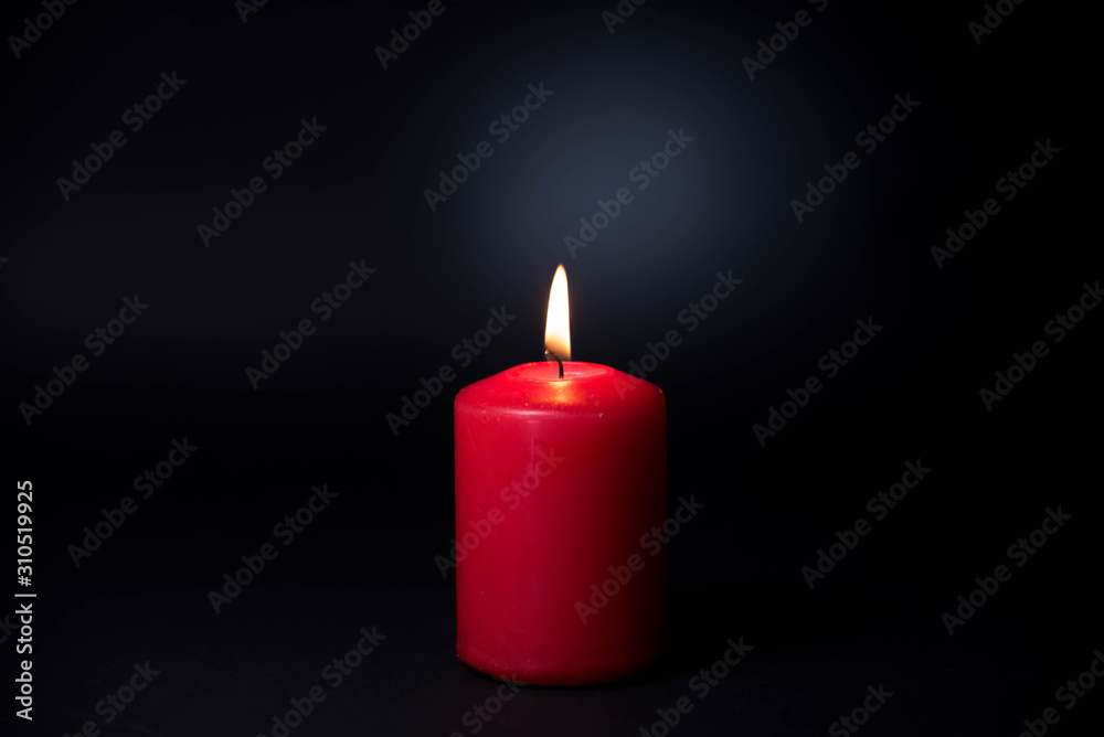 The candle in the darkness, A burnig candle with black backgroud The candle in the darkness, A burnig candle with black backgroud