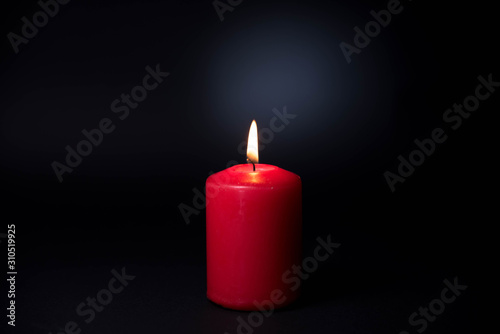 The candle in the darkness, A burnig candle with black backgroud