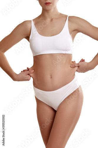 Young body of girl in white underwear, showing - Stock Photo