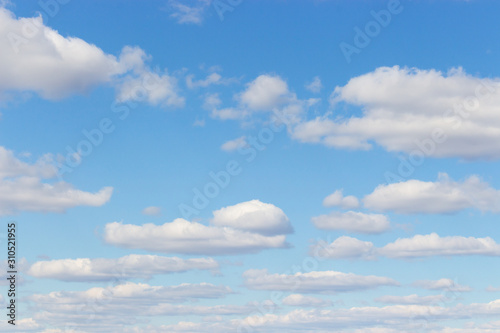 Cloudy sky. Light blue sky with puffy cumulus clouds  heavenly landscape. Background wallpaper backdrop texture. summer cloudy day